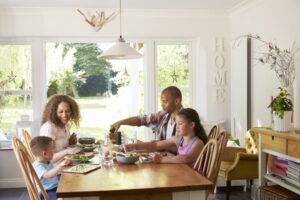 family-sitting-around-dinner-table