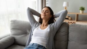 woman-leaning-back-comfortably-on-couch