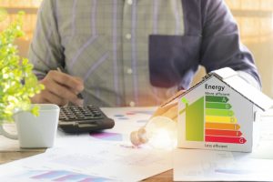 person-calculating-money-saved-by-making-home-more-efficient